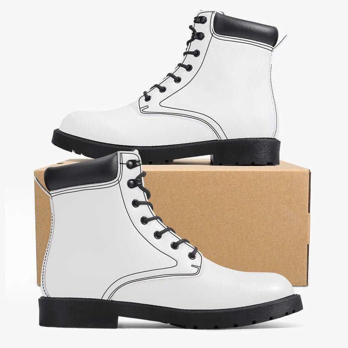 a pair of white boots sitting on top of a cardboard box