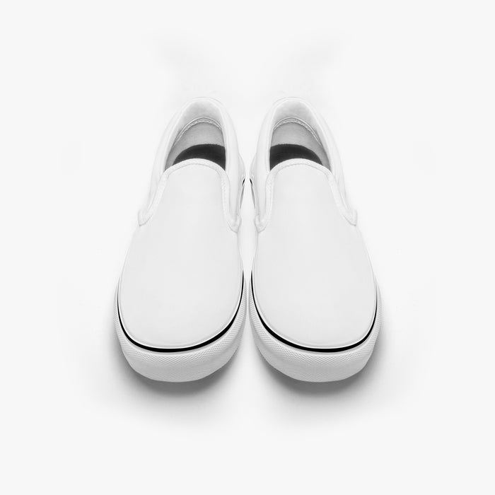 a pair of white shoes sitting on top of a white floor