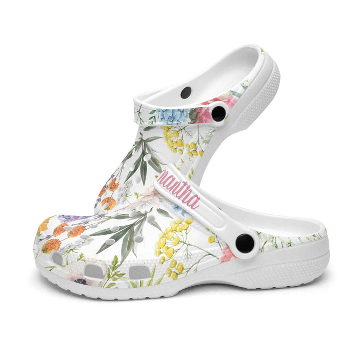 a pair of white shoes with colorful flowers on them