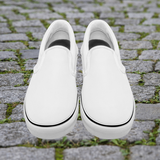 a pair of white shoes sitting on top of a sidewalk